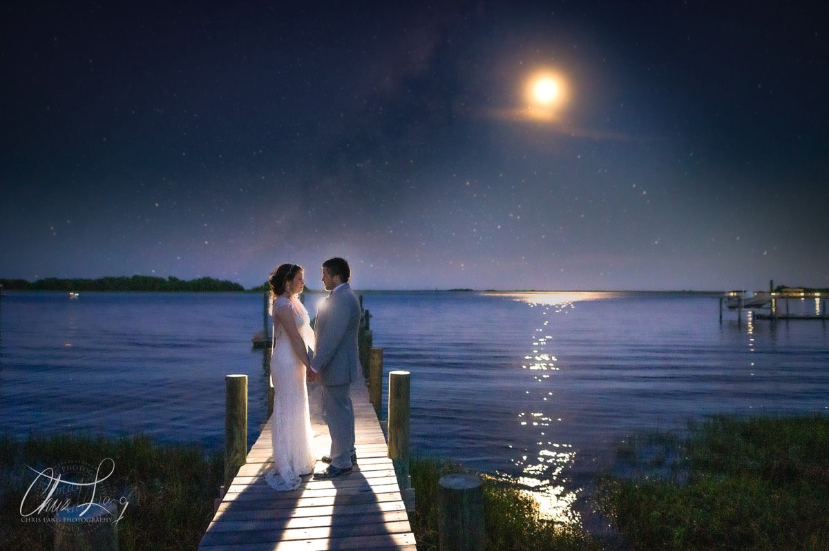Signature Wedding Photo - Lifestlye Wedding Photography - Bride & gromm on a dock under moonlit sky- intercoastal waterway- Wilmington NC Wedding Photographer - Wedding Photography - Wedding Photo - Chris Lang Photography